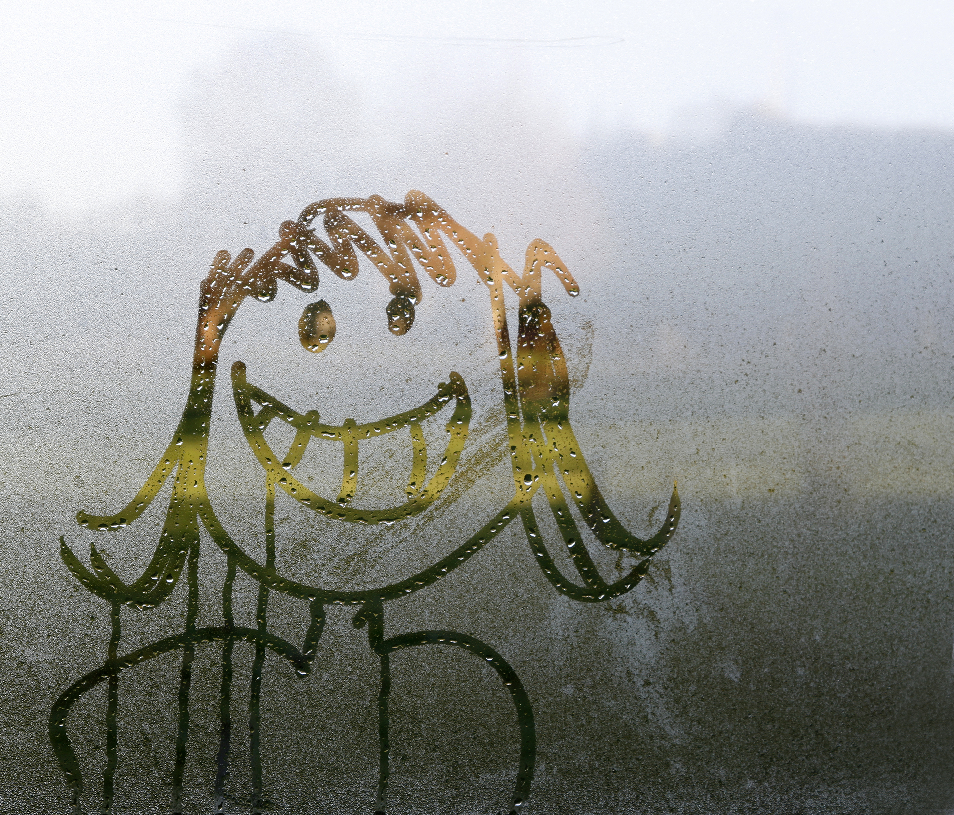 Smiley face drawn on condensation on window